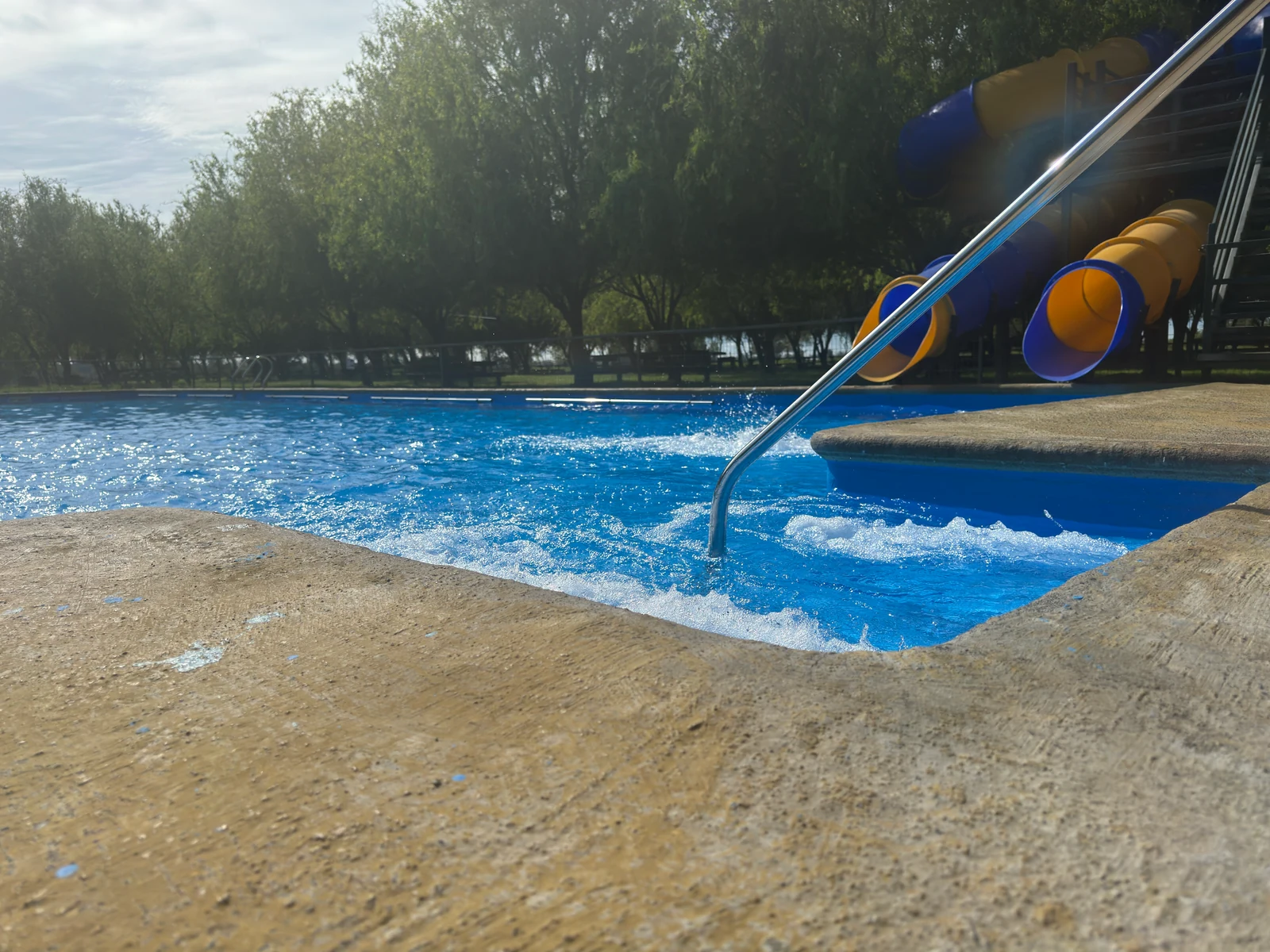 Agua en movimiento junto a la baranda de acceso y la llegada de los toboganes del sector 2